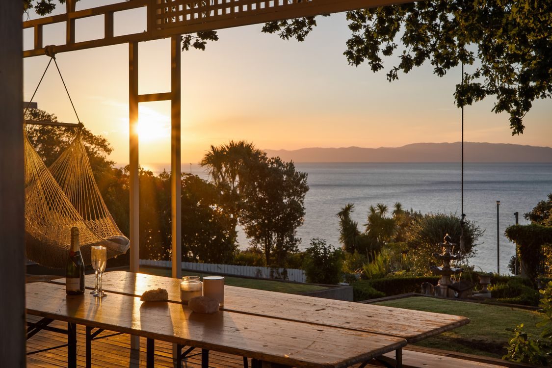 The deck at sunset, a hammock chair facing the sea