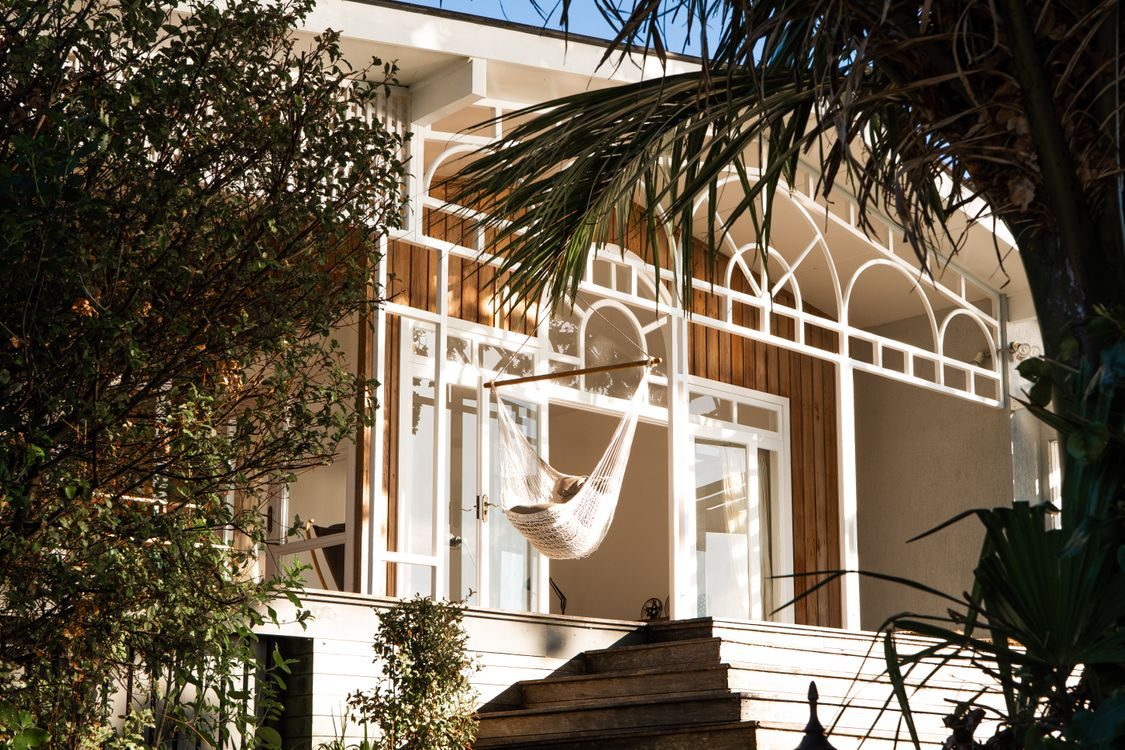 A hammock on the timber veranda among the planting