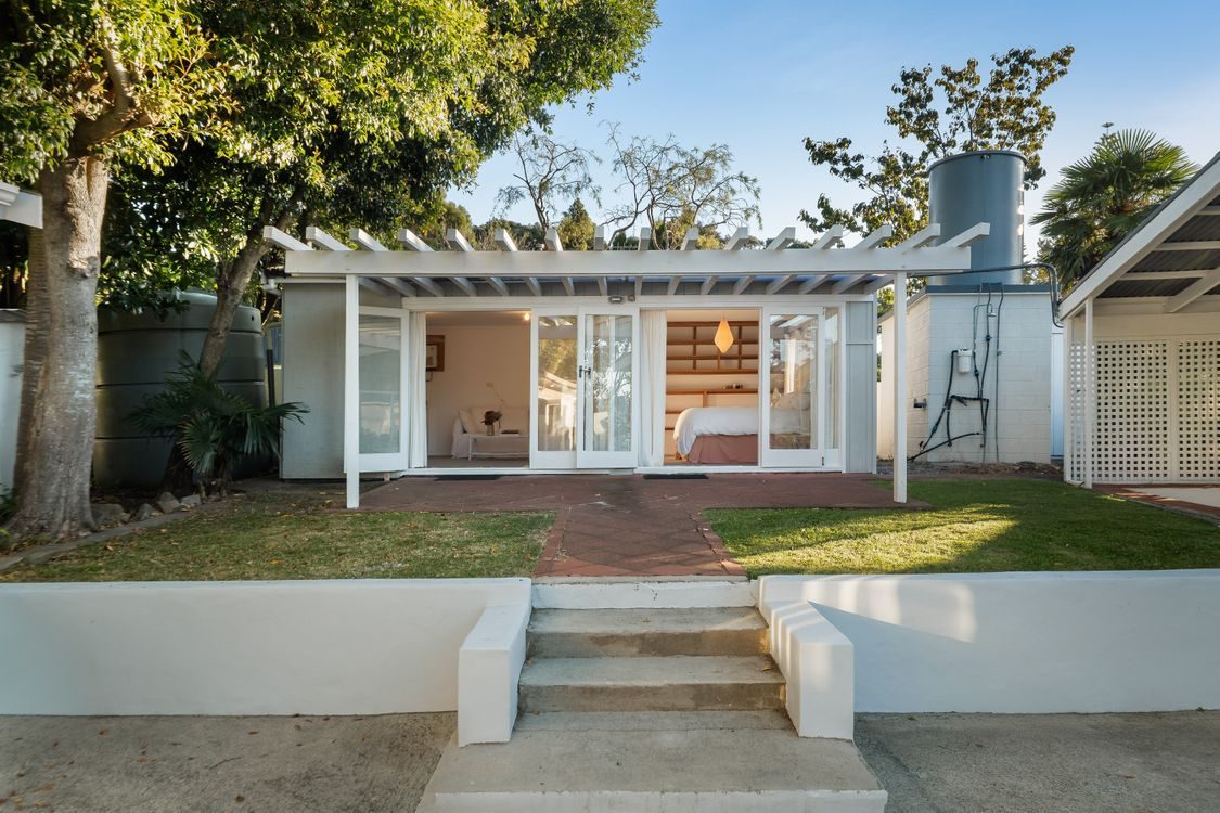 The white weatherboard home and its lawn