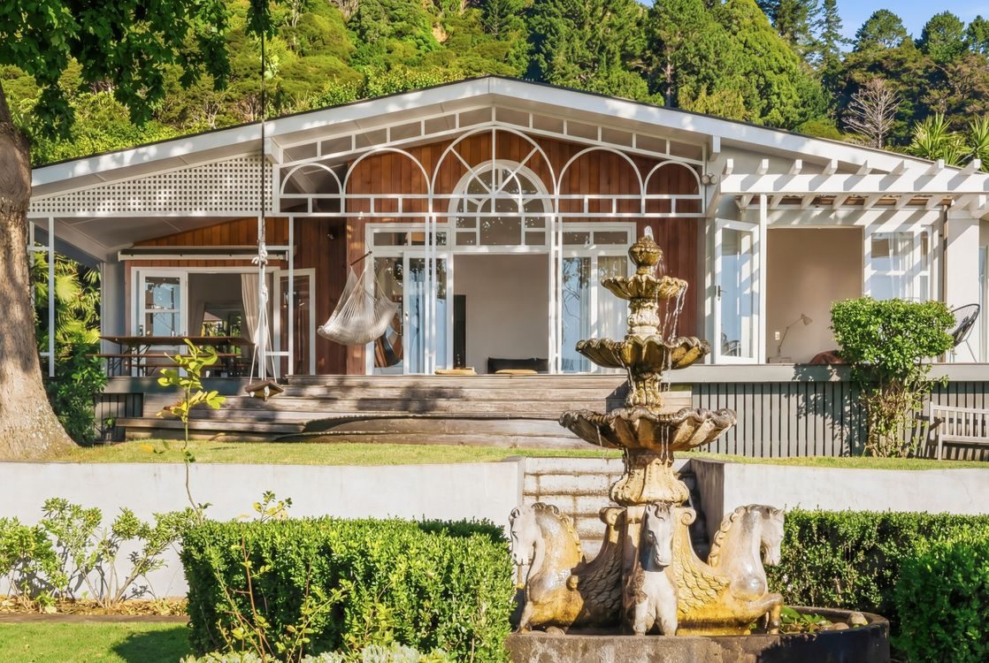 The character timber frontage with a fountain in the garden