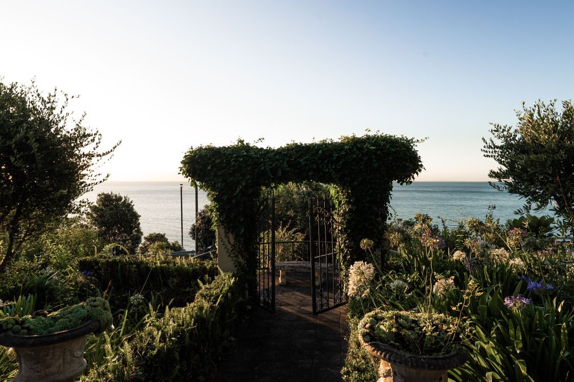 A topiary arch framing the sea