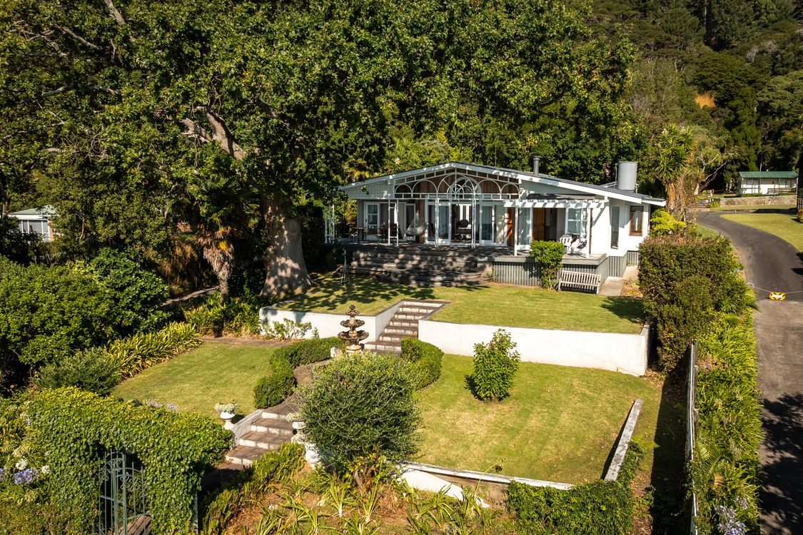 The home in its parklike, hedged grounds from above