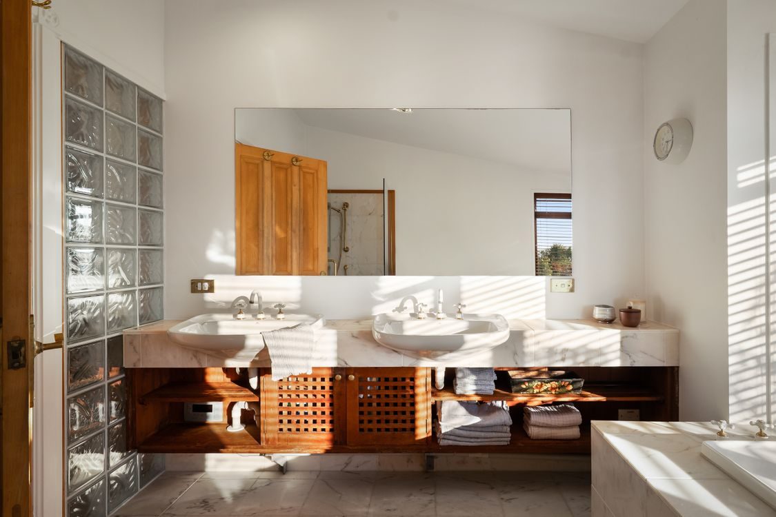 Bathroom with a double vanity, marble and timber cabinetry