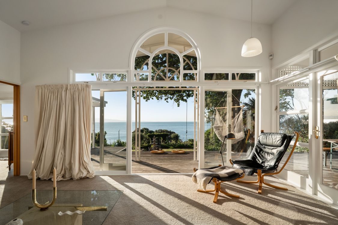 Living room with arched windows opening to the sea
