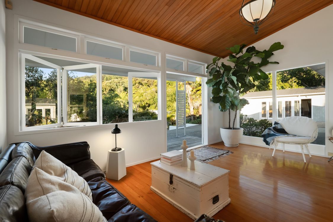 Lounge under a timber ceiling, windows to the garden